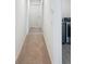 Hallway leading to laundry room features carpet flooring and is painted a neutral color at 5310 Companion Ln, Tampa, FL 33619