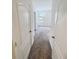 Hallway view leading into a carpeted bedroom with natural light, showcasing the home's layout at 5310 Companion Ln, Tampa, FL 33619
