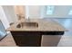 Kitchen island features a stainless steel sink, granite countertop, and a dishwasher at 5310 Companion Ln, Tampa, FL 33619