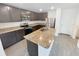 Modern kitchen boasts stainless steel appliances, granite countertops, and a center island with a sink at 5310 Companion Ln, Tampa, FL 33619