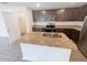 Stylish kitchen with an island, granite countertops, stainless steel appliances, and dark cabinets at 5310 Companion Ln, Tampa, FL 33619
