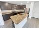 Modern kitchen boasts stainless steel appliances, granite countertops, and a center island with a sink at 5310 Companion Ln, Tampa, FL 33619