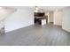 Spacious living room features wood-look flooring and an open floor plan to the kitchen area at 5310 Companion Ln, Tampa, FL 33619