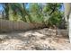 Large backyard featuring a wood fence and mature trees with foliage overhead at 6208 Rolling Hammock, Tampa, FL 33610