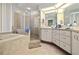 Spacious bathroom featuring a tiled tub, glass shower, and ample counter space at 6237 Greenwich Dr, Tampa, FL 33647