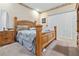 Cozy bedroom featuring a wooden bed frame, neutral carpet, and ample natural light at 6237 Greenwich Dr, Tampa, FL 33647