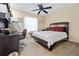Bedroom with a dark wood bed frame, desk, and a ceiling fan at 6237 Greenwich Dr, Tampa, FL 33647