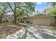 Charming one story home featuring a brick facade, attached garage, and mature landscaping at 6237 Greenwich Dr, Tampa, FL 33647