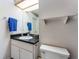 Bathroom featuring a single sink vanity and wallpaper with a dot pattern at 625 Fayette S Dr, Safety Harbor, FL 34695