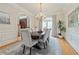 Formal dining room boasts a dark wood table and hardwood floors at 6310 W Maclaurin Dr, Tampa, FL 33647