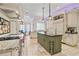 Large kitchen with a center island, stainless steel appliances, custom cabinets, and stone tile flooring at 6310 W Maclaurin Dr, Tampa, FL 33647