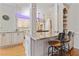 Kitchen with granite countertops, white cabinets, stainless steel appliances, and a breakfast bar at 6310 W Maclaurin Dr, Tampa, FL 33647