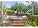 Elegant stone patio with brick stairs, outdoor seating, and lush landscaping perfect for outdoor entertaining at 6310 W Maclaurin Dr, Tampa, FL 33647
