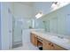 Well-lit bathroom with a glass-enclosed shower, double sinks, and ample counter space at 7107 Colonial Lake Dr, Riverview, FL 33578