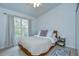 Serene bedroom with a queen-sized bed, large window for natural light, and neutral decor at 7107 Colonial Lake Dr, Riverview, FL 33578