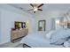 Cozy bedroom featuring soft colors, a large dresser, and a comfortable bed with decorative pillows at 7107 Colonial Lake Dr, Riverview, FL 33578