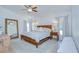 Comfortable bedroom with soft lighting, large windows with curtains, and a decorative area rug at 7107 Colonial Lake Dr, Riverview, FL 33578