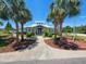 Community clubhouse surrounded by manicured landscaping and stately palm trees at 7107 Colonial Lake Dr, Riverview, FL 33578