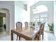 Bright dining room features a large window, decorative chandelier, and a dining table that seats six at 7107 Colonial Lake Dr, Riverview, FL 33578