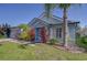 Charming single-story home featuring a blue exterior, a manicured lawn, and a two-car garage at 7107 Colonial Lake Dr, Riverview, FL 33578