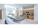 Open-concept kitchen with breakfast bar, granite countertops, and stainless steel appliances at 7107 Colonial Lake Dr, Riverview, FL 33578
