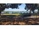 Scenic lake view with a bench under the shade at 7107 Colonial Lake Dr, Riverview, FL 33578