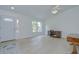 Bright living area with hardwood floors, white walls, and a view of the front door and window at 7107 Colonial Lake Dr, Riverview, FL 33578