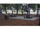 Community picnic area with tables, a trash can, and mature trees at 7107 Colonial Lake Dr, Riverview, FL 33578