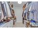Spacious walk-in closet with custom shelving, providing ample storage for clothing and accessories at 7107 Colonial Lake Dr, Riverview, FL 33578