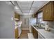 The kitchen has a white appliance package, marble countertops, wood-look vinyl flooring, and light oak cabinetry at 712 Cordova Greens # 712, Largo, FL 33777