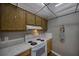 Functional kitchen featuring white appliances, marble countertops, and ample cabinet space, perfect for meal preparation at 712 Cordova Greens # 712, Largo, FL 33777