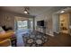 Bright living room features a ceiling fan, wood floors, and view of pool and landscaped backyard at 712 Cordova Greens # 712, Largo, FL 33777