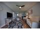 Comfortable living room features a ceiling fan, light walls, and hardwood floors at 712 Cordova Greens # 712, Largo, FL 33777
