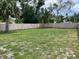 Wide view of a grassy backyard featuring a wooden fence at 7635 N 55Th N St, Pinellas Park, FL 33781