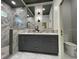 Bathroom featuring double sinks, glass-enclosed shower, and dark gray vanity at 7635 N 55Th N St, Pinellas Park, FL 33781