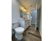 Bright bathroom with updated vanity, flooring, and modern toilet at 7635 N 55Th N St, Pinellas Park, FL 33781