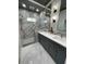 Modern bathroom features double sinks, gray cabinets, and stylish light fixtures above vanity at 7635 N 55Th N St, Pinellas Park, FL 33781