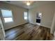 Bright bedroom with wood floors and natural light coming through two windows at 7635 N 55Th N St, Pinellas Park, FL 33781