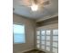 Bright bedroom with a ceiling fan, built in shelves and closet with unique geometric doors at 7635 N 55Th N St, Pinellas Park, FL 33781