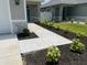 Landscaped walkway leading to the home's entrance, featuring well-maintained plantings and attractive curb appeal at 7635 N 55Th N St, Pinellas Park, FL 33781