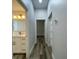 Hallway featuring stylish flooring and a view of the updated bathroom at 7635 N 55Th N St, Pinellas Park, FL 33781