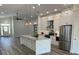 Renovated kitchen with white cabinets, granite countertops, and stainless steel appliances at 7635 N 55Th N St, Pinellas Park, FL 33781