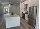 Open kitchen with white cabinets, stainless steel appliances, and a large center island at 7635 N 55Th N St, Pinellas Park, FL 33781