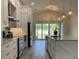 Open-concept kitchen with sleek appliances, a center island, and seamless access to the outdoor patio at 7635 N 55Th N St, Pinellas Park, FL 33781