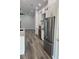 Modern kitchen with stainless steel appliances, white cabinetry and sleek gray floors at 7635 N 55Th N St, Pinellas Park, FL 33781