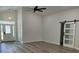 Bright living room boasts modern ceiling fan, wood floors, and stylish barn door at 7635 N 55Th N St, Pinellas Park, FL 33781