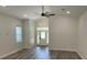 Open-concept living room showing the front entrance, high ceilings, hardwood floors, and natural light from multiple windows at 7635 N 55Th N St, Pinellas Park, FL 33781