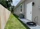 Side view of the house, showcasing a well-maintained lawn and a practical exterior door for easy access at 7635 N 55Th N St, Pinellas Park, FL 33781