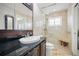 Tiled bathroom featuring a shower, toilet, and vanity with granite counters at 811 Woodley Rd, Clearwater, FL 33764