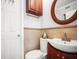 Bathroom with toilet, sink, and oval mirror at 811 Woodley Rd, Clearwater, FL 33764